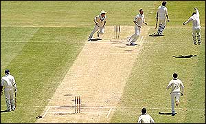 Australia celebrate the fall of England's Michael Vaughan, who is dismissed for just nine runs after being run out