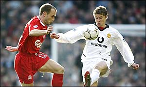 Ole Gunnar Solskjaer tussles with Danny Murphy during a tight first half