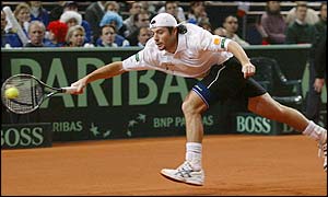 Sebastien Grosjean stretches to return a shot from Marat Safin