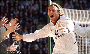 Diego Forlan celebrates his second goal with the travelling fans