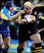 Wasps hooker Trevor Leota tries to escape the tackle of Leeds centre Braam van Straaten 
