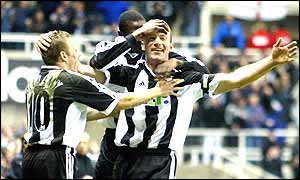 Alan Shearer is congratulated by his team-mates after his stunning goal