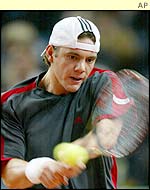 Paul-Henri Mathieu hits a backhand to Mikhail Youzhny