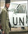 An Iraqi soldier stands guard near a UN vehicle