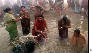 People bathe at the confluence of Ganges, Jamuna and Saraswati rivers during Kumbh Mela