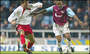 West ham striker Jermain Defoe holds off Southampton defender Claus Lundekvam