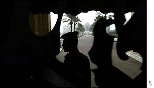 Guard behind gate to palace
