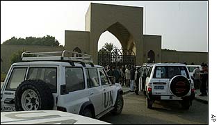 Inspectors wait outside palace gates