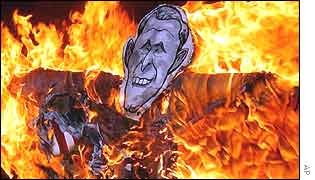 An effigy of US President George Bush is set fire by anti-US protesters in a rally in Seoul on Saturday