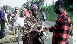 Civilians man a check-point near the western town of Man