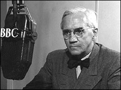 Head shot of Fleming in front of microphone