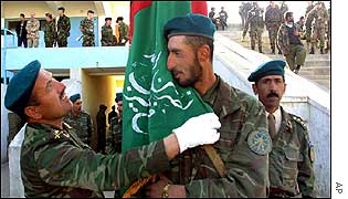 National guard officer adjusts Afghan flag