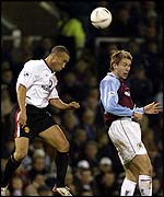 Manchester United defender Mikael Silvestre goes for the ball with Gareth Taylor of Burnley