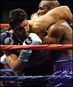 John Ruiz (left) grapples with Evander Holyfield