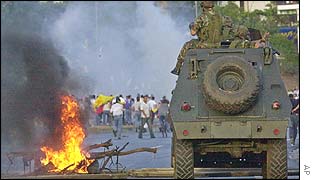 Venezuelan national guard fires tear gas at protesters outside the state-owned oil company