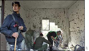 Palestinians examine the damage after several missiles hit a building in Gaza