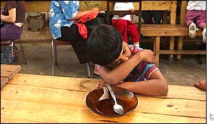 A boy waits to be served at Los Piletones soup kitchen in Argentina