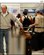 Passengers wait in line for a ticket agent at United's terminal in Chicago O'Hare International Airport.
