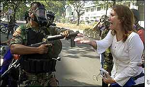 Protester remonstrates with soldier in Caracas on Tuesday