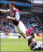 Gareth Barry goes flying over the challenge of Newcastle keeper Shay Given