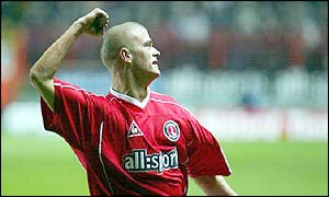 Paul Konchesky punches the air with delight after scoring against Liverpool