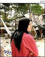 A Muslim woman looks at the ruins of a Brisbane mosque