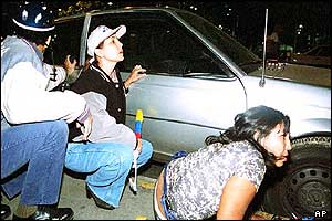 People take cover during shooting incident in Caracas 