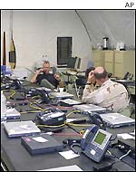 Technicians set up lap tops for use in the exercise