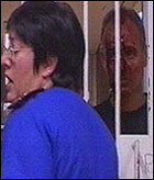 Man with blood-stained face outside steel gate