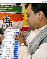 Shopkeeper displays an electronic voting machine in Ahmedabad, Gujarat