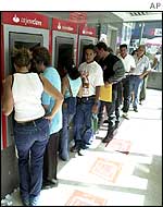A line of people waiting to withdraw money