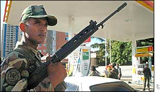 A soldier guards a petrol station in Maracaibo