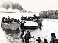 Servicemen escape the burning Sir Galahad on 8 June (PA)