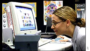 Woman looks closely at computer screen