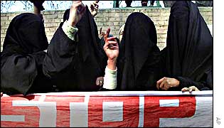 Women in Kashmir holding up banner