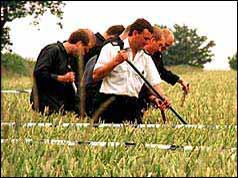 Photo of police searching fields near the Russell family home