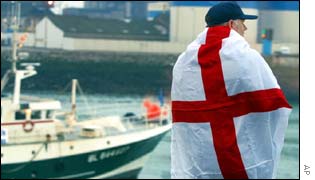 An unidentified fisherman stands on the port of Boulogne-sur-Mer, northern France, draped in the English flag