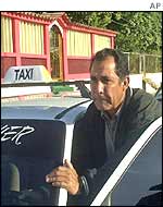 A driver pushes his taxi