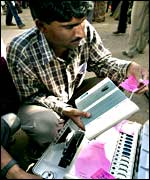 Election officials inspect voting machines before sending them to polling stations in Ahmedabad