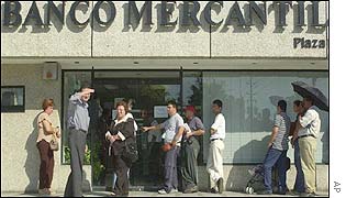 A long line of customers forms at Mercantil Bank in the western town of Maracaibo