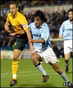 Celtic striker Henrik Larsson battles with Jose Ignacio