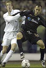 Leeds midfielder Lee Bowyer (left) tangles with Gerardo of Malaga