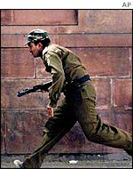 Policeman runs for cover outside Indian Parliament, 13 December