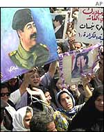 Iraqis attend a Saddam rally in Baghdad