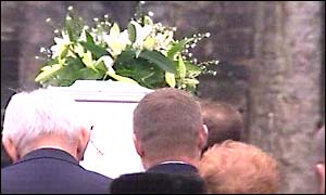 Stuart's coffin is carried into the funeral service