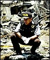 An Indonesian police officer surveys the ruins of the Bali bombing