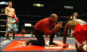 Ricky Hatton stands in the corner as Hutchinson is counted out