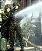 Two soldiers fight a fire