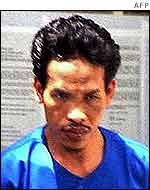 Indonesian police officers take Bali bombing suspect, Mukhlas (C) alias Ali Ghufron, to the investigation room in Bali