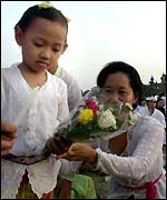 Child lays a memorial to the dead